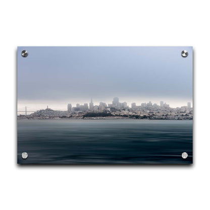 A photo of San Francisco bay taken from Vista Point. The long exposure of the photo creates a smoothing effect on the dark waters, and a heavy cloud of fog site just across the top of the city on the horizon. Printed on acrylic.