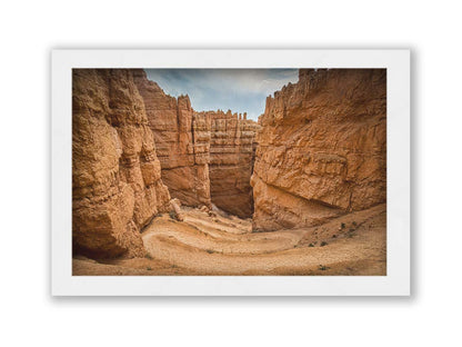 A photo of the Wall Street rock formation at Bryce Canyon National Park in Utah. The layers of stone create walls bordering a staircase-like path down through the canyon. Printed on canvas and framed.