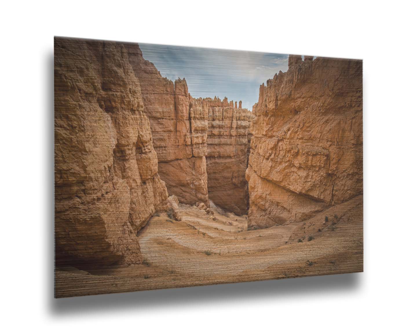 A photo of the Wall Street rock formation at Bryce Canyon National Park in Utah. The layers of stone create walls bordering a staircase-like path down through the canyon. Printed on metal.