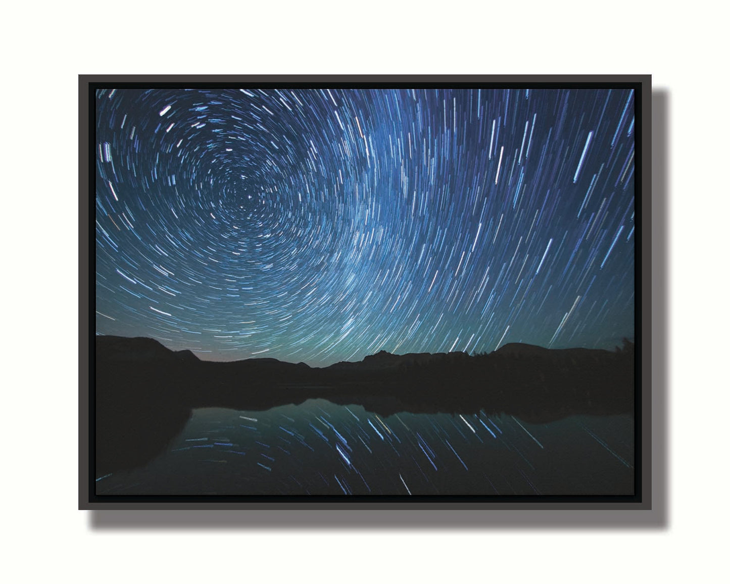 A photo of the Perseid Meteor shower reflecting off of Mirror Lake in Utah. Printed on canvas in a float frame.