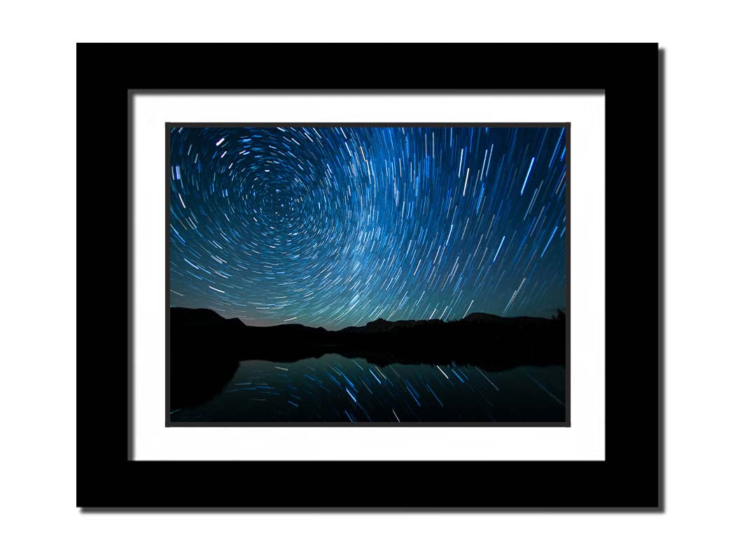 A photo of the Perseid Meteor shower reflecting off of Mirror Lake in Utah. Printed on paper, matted, and framed.