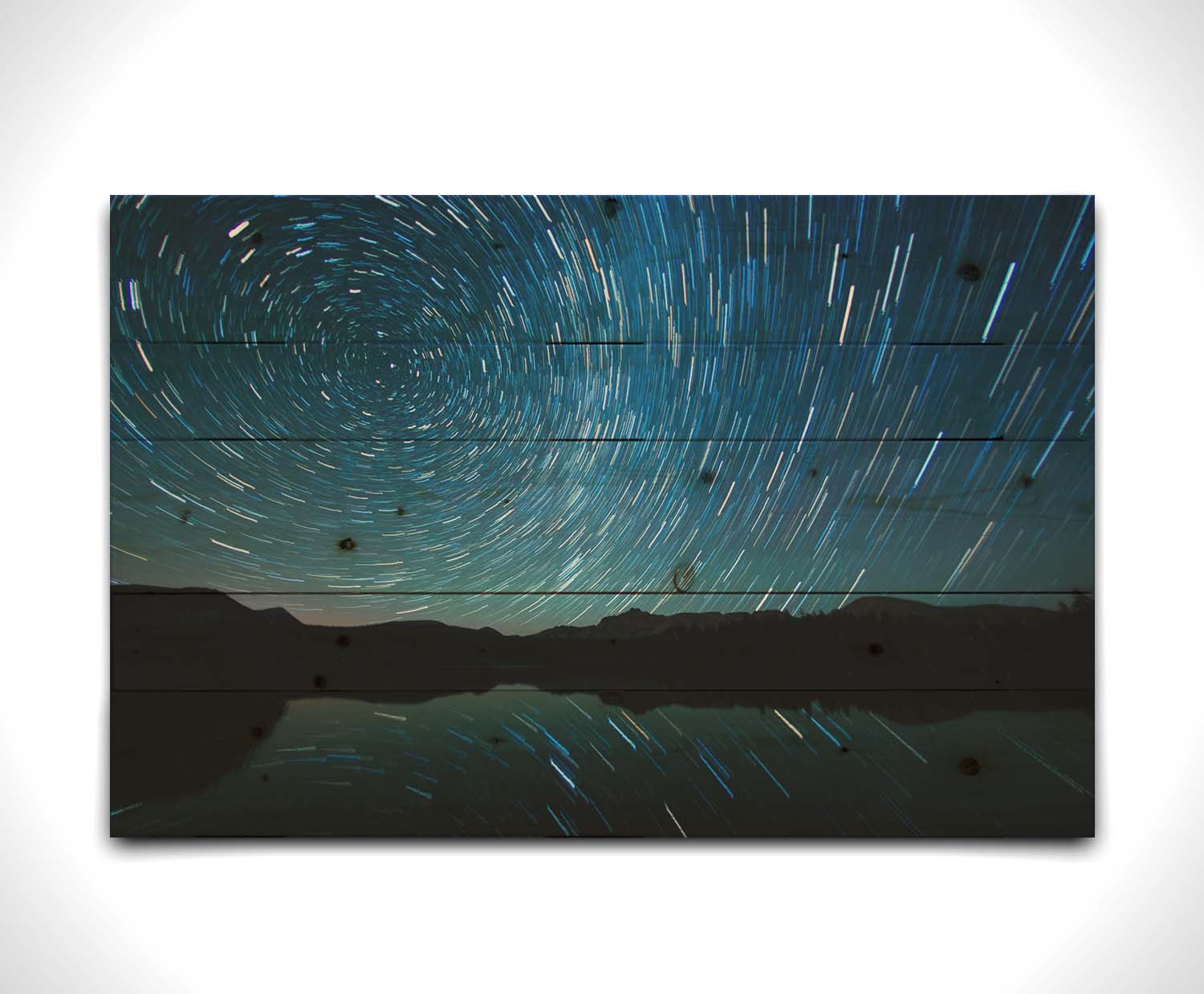 A photo of the Perseid Meteor shower reflecting off of Mirror Lake in Utah. Printed on a wood pallet.