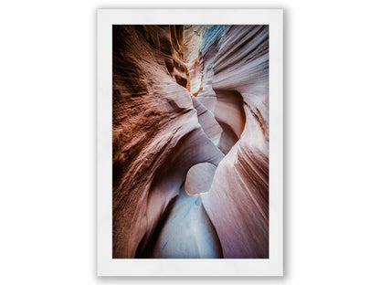 A photo looking through Peek-A-Boo slot canyon near Escalante, Utah. The wavy layers of sandstone have an unusual, surreal appearance. Printed on canvas and framed.