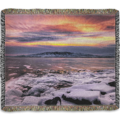 A woven throw blanket designed with the photo of a sunset over an icy lake at Mount Timpanogos, Utah, one Christmas evening.