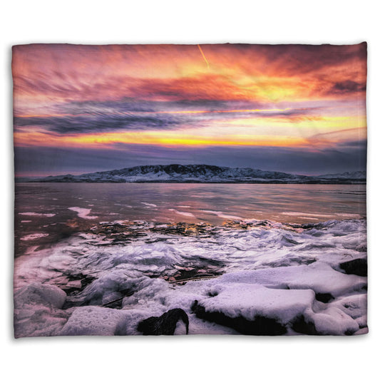 A coral fleece blanket designed with the photo of a sunset over an icy lake at Mount Timpanogos, Utah, one Christmas evening.