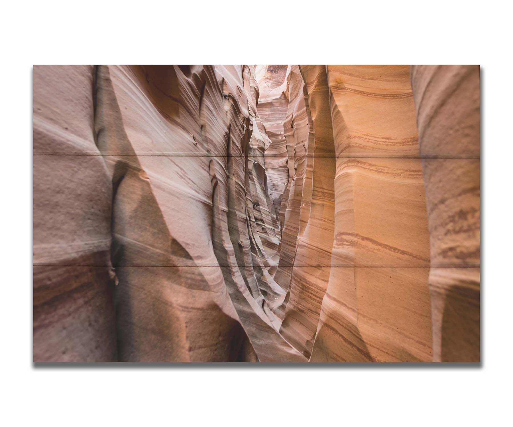 A photo of the Zebra Slot Canyon at Grand Staircase-Escalante National Monument, Utah. The red and orange sandstone stripes alternate in sharp waves down the length of the narrow passageway. Printed on a box board.