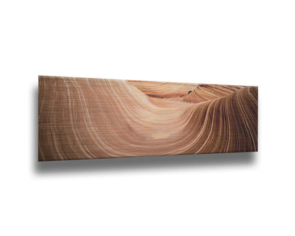 A panoramic photo of the Wave rock formation, at the Coyote Buttes North area of the Utah-Arizona border. The stripes of reddish-brown stone create a unique wave-like shape. Printed on metal.