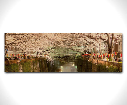 Photo of cherry blossom trees over a canal at Meguro River in Tokyo, Japan. Printed on a wood pallet.