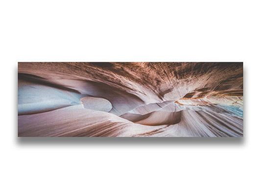 A photo looking through Peek-A-Boo slot canyon near Escalante, Utah. The wavy layers of sandstone have an unusual, surreal appearance. Printed on canvas.