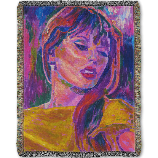 Colorful woven blanket patterned with an impressionist portrait of Taylor Swift.
