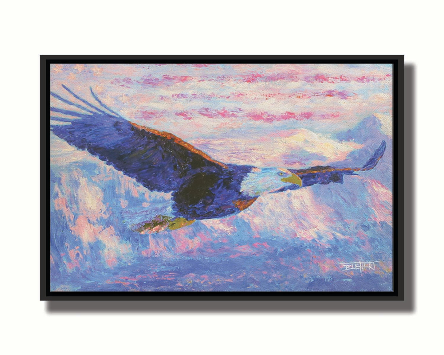 Painting of an eagle flying over the mountains using a red, white, and blue themes palette. Printed on canvas in a float frame.