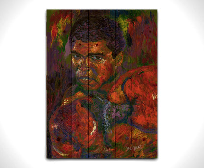 A painting of boxer Muhammad Ali in a fighting stance with boxing gloves on, against a purple and green background. Printed on a wood pallet.