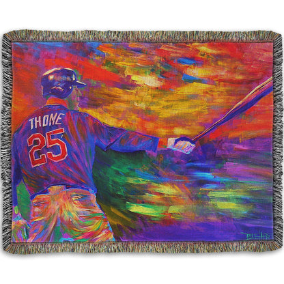 A woven throw blanket designed with a painting of baseball player Jim Thome holding a baseball bat. It is painted using arbitrary color, in a vibrant spectrum of hues.