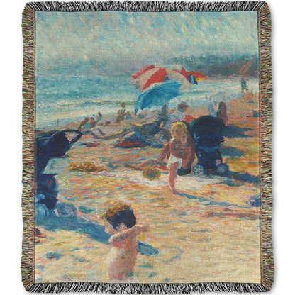 A woven throw blanket designed with a painting of a busy beach during the summer. People sit under umbrellas all along the sand, and in the foreground, two small children play.