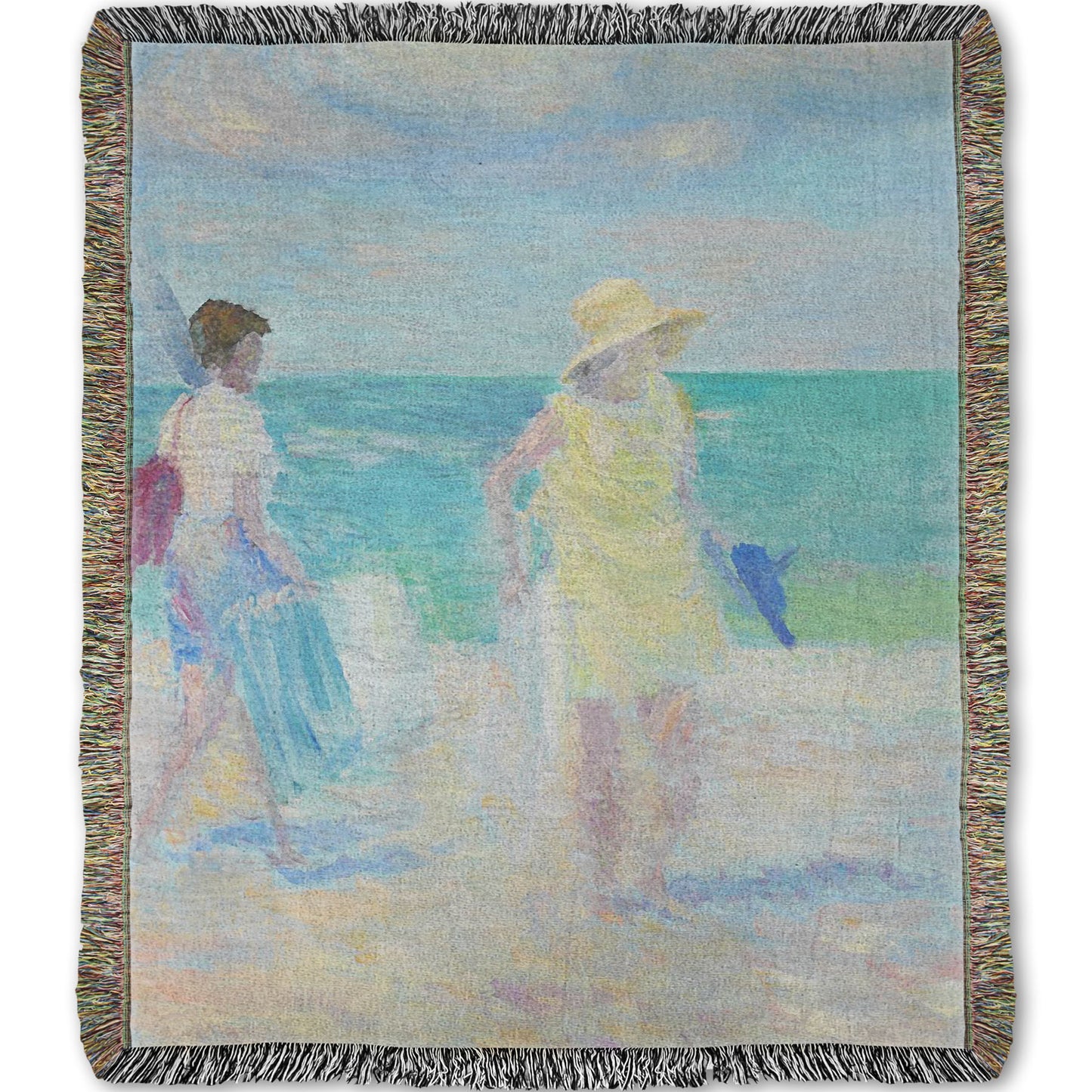 A woven throw blanket designed with a painting of two people on the beach, carrying towels and chairs and umbrellas. The ocean is calm behind them as they walk through the sand.