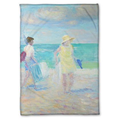 A fleece throw blanket designed with a painting of two people on the beach, carrying towels and chairs and umbrellas. The ocean is calm behind them as they walk through the sand.