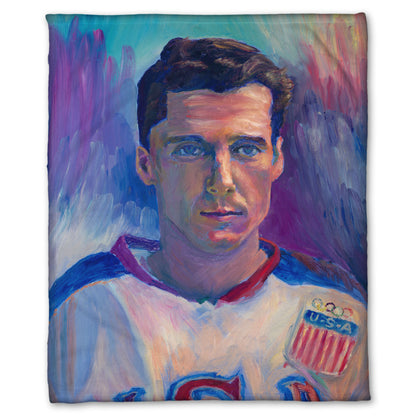 A fleece throw blanket designed with a portrait painting of a United States Olympic hockey player in a cool color pallet of blues, purples, and pinks.
