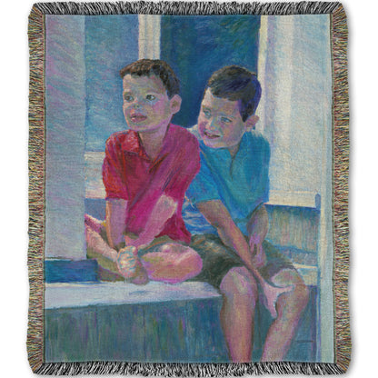 A woven throw blanket designed with a painting of two children sitting on a window ledge.