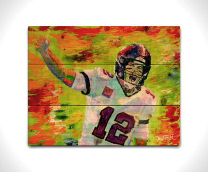 A painting of American football player Tom Brady yelling with his fist in the air, rallying his teammates. Arbitrary colors and visible brushstrokes add to the energy of this painting, alongside the bright greens, reds, and oranges of the backdrop. Printed on a wood pallet.