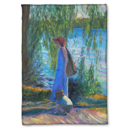 Fleece blanket designed with a painting of a woman walking by a lake with a child, who is playing in the dirt.
