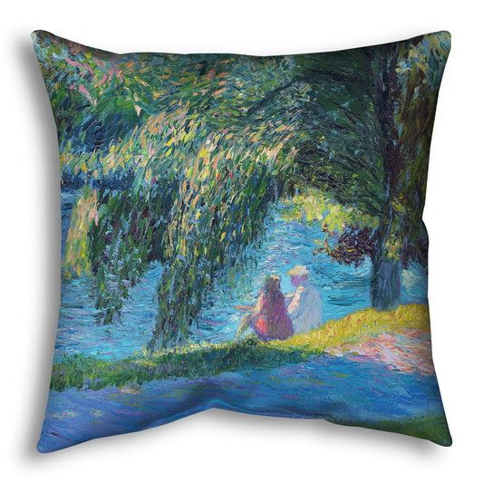 A square throw pillow designed with a painting of two people sitting by the water, near a park sidewalk, with a large tree above them.