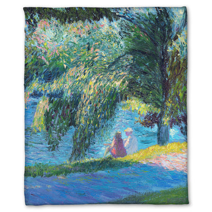 A fleece blanket designed with a painting of two people sitting by the water, near a park sidewalk, with a large tree above them.