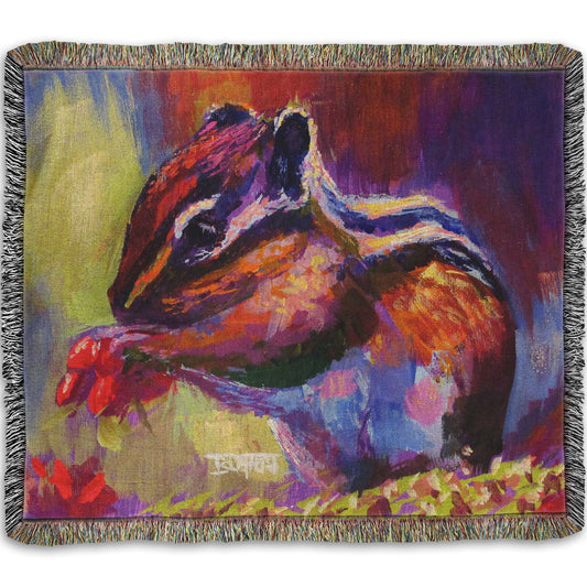 Woven throw blanket designed with a painting of a chipmunk eating red berries, in a red and purple color palette using visible brush strokes. 