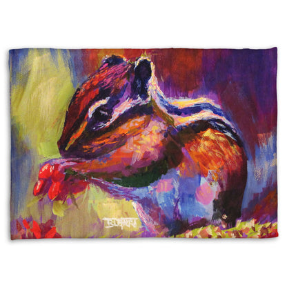 Fleece blanket designed with a painting of a chipmunk eating red berries, in a red and purple color palette using visible brush strokes. 