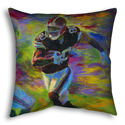 A throw pillow designed with a painting of a football player running across the field with the ball, narrowly avoiding the opposing team's players.