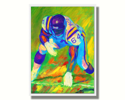 A painting of a football player, wearing white and purple, crouched on a bright green field. Printed on canvas in a float frame.