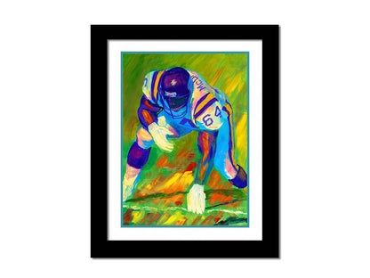 A painting of a football player, wearing white and purple, crouched on a bright green field. Printed on paper, matted, and framed.