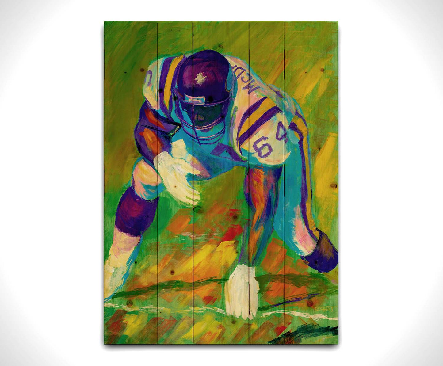 A painting of a football player, wearing white and purple, crouched on a bright green field. Printed on a wood pallet.