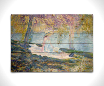 A painting of a person in a dress and sunhat, sitting on a blanket in the shade of trees by a lake, reading a book. Printed on a wood pallet.