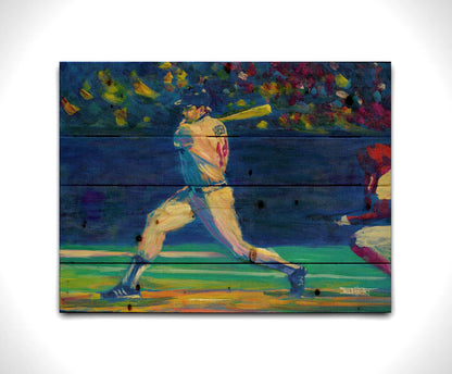 A painting of Minnesota Twins baseball player Kent Hrbek swinging a bat on the field. Printed on a wood pallet.