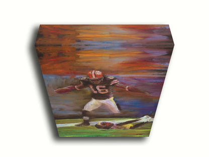 A painting of Cleveland Browns football player Josh Cribbs as he runs with the ball, dodging over another playerr. Printed on canvas.