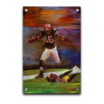 A painting of Cleveland Browns football player Josh Cribbs as he runs with the ball, dodging over another playerr. Printed on acrylic.