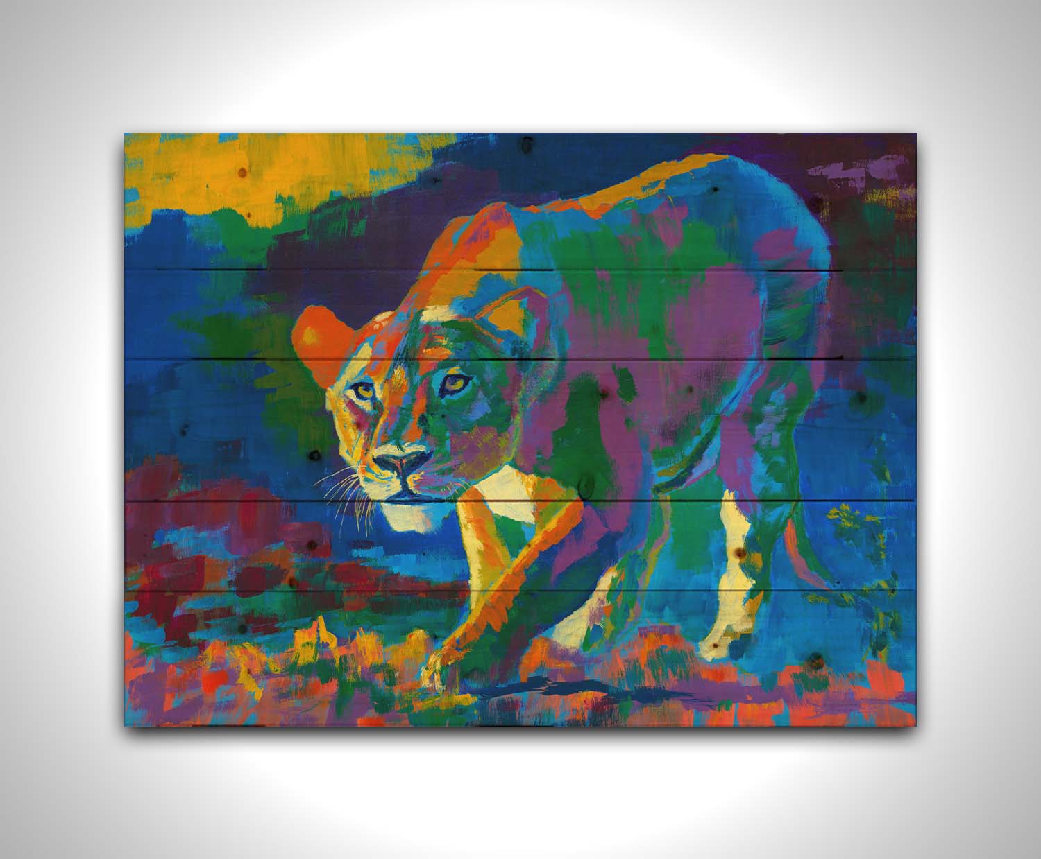 A painting of a lioness on the hunt. It is painted using arbitrary color, across a broad spectrum. Printed on a wood pallet.