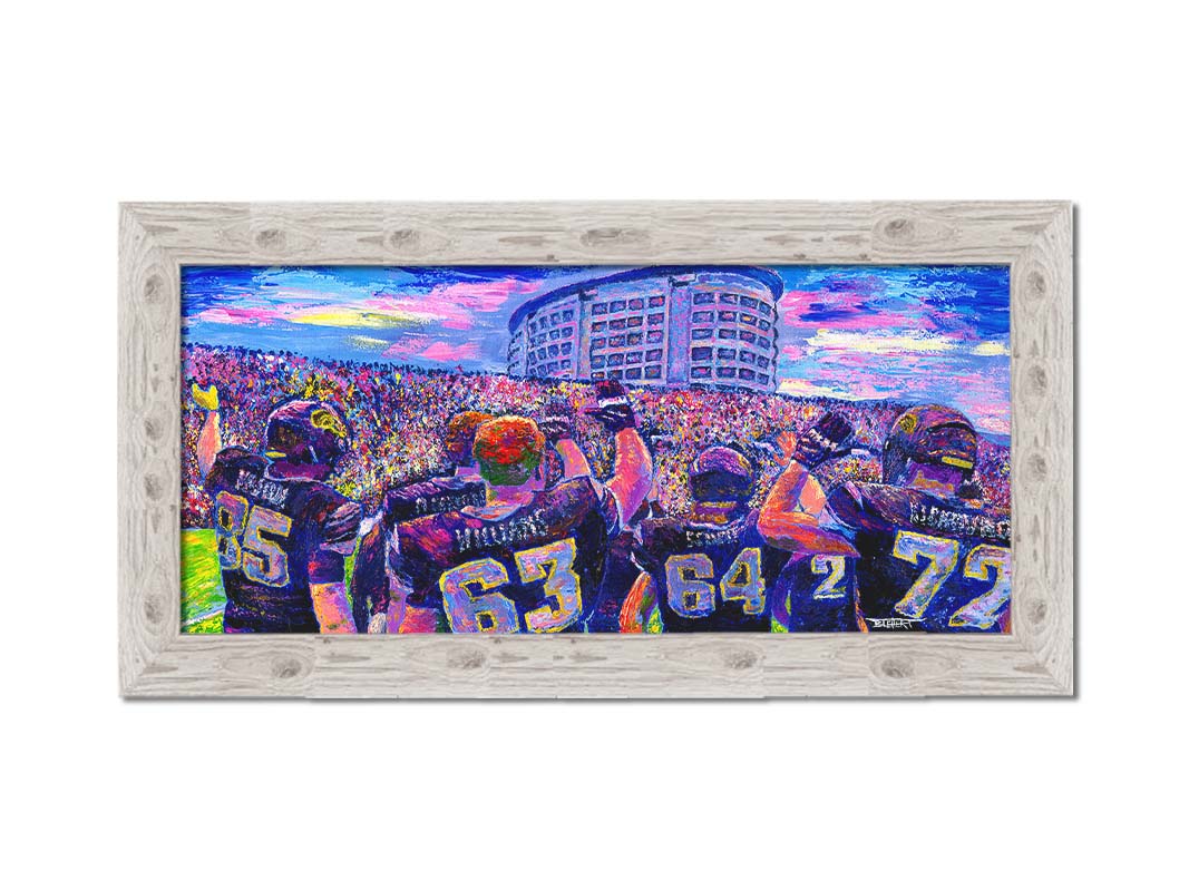 A painting of the Iowa Hawkeyes football team from behind, waving at the massive crowd of fans in front of them. Printed on canvas and framed.