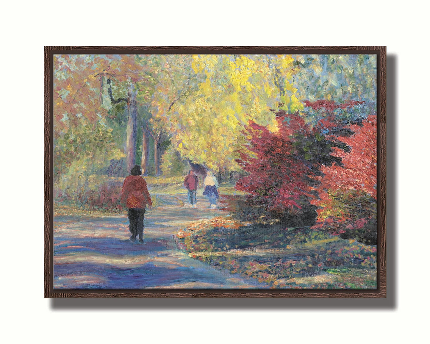 A painting of people walking in a park, the leaves changing to yellows and reds for autumn. Printed on canvas in a float frame.