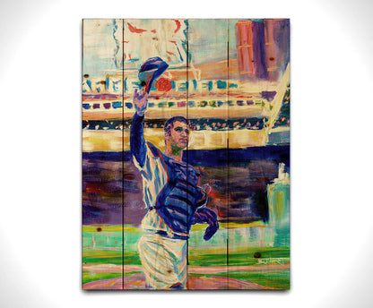 A painting of catcher Joe Mauer of the Minnesota Twins baseball team, standing in the field and waving his hat. Printed on a wood pallet.