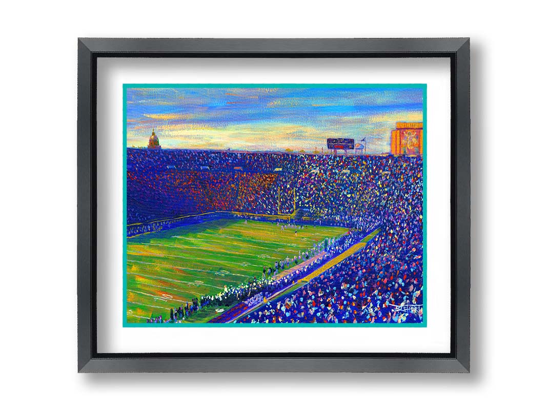 A painting of the Notre Dame Stadium in Notre Dame, Indiana. The stands are full as the crowd excitedly watches the football game. Printed on paper, matted, and framed.