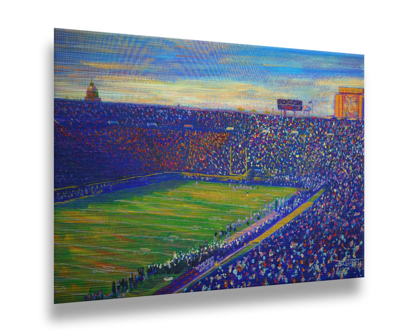 A painting of the Notre Dame Stadium in Notre Dame, Indiana. The stands are full as the crowd excitedly watches the football game. Printed on metal.