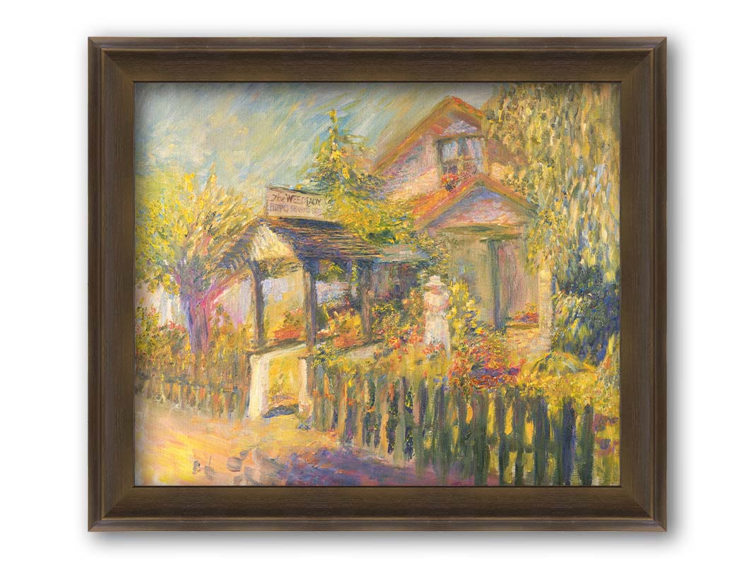 A painting of The Weed Lady florals and landscaping store. The road passes a fenced garden, with the store sign above a covered path. a variety of trees, bushes, and flowers are being gardened in the yard of the building. Printed on canvas and framed.