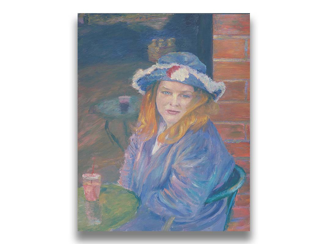 A portrait of a person in a blue outfit, sitting at a table outside a brick building with a drink. Printed on canvas.