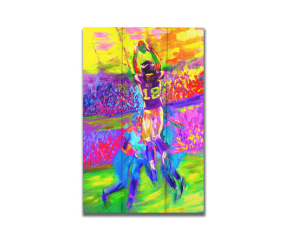 A painting of Minnesota Vikings football player Sidney Rice making an impressive catch during a game. It is painted in a bright, vivid palette with visible brushstrokes, emphasizing the energy of the game. Printed on a box board.