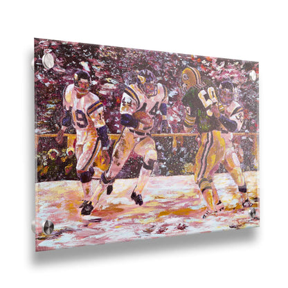 A painting of a snowy scene during the November 1977 football team between the Minnesota Vikings and the Green Bay Packers, centering on Vikings player Chuck Foreman as he runs the ball past an opponent with the help of his teammates. Printed on acrylic.