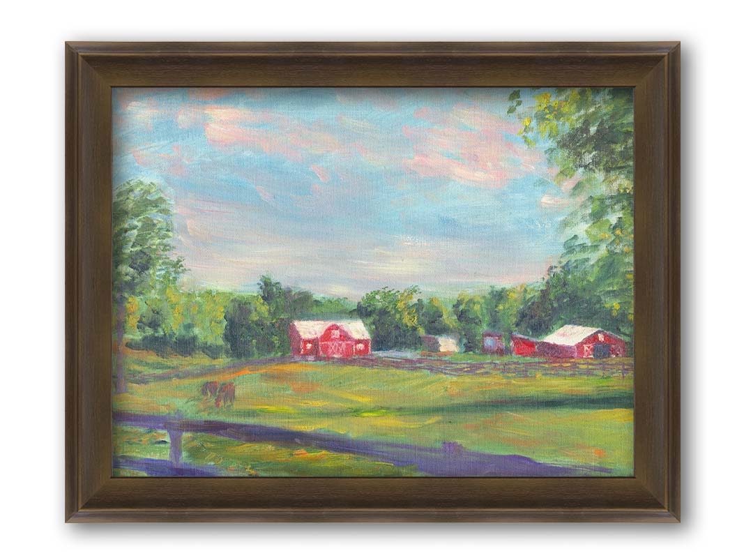 A painting of a fenced field, where horses are grazing, Red barns stand on the other side of the pasture, contrasting against the green trees behind themâ€“ all under a wide, open sky. Printed on canvas and framed.