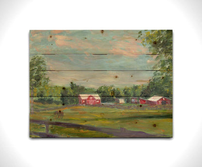 A painting of a fenced field, where horses are grazing, Red barns stand on the other side of the pasture, contrasting against the green trees behind themâ€“ all under a wide, open sky. Printed on a wood pallet.