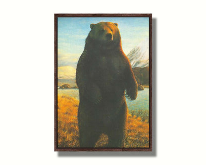 A portrait painting of a brown bear standing on its back legs in a yellow field, next to a lake and mountain range. Printed on canvas in a float frame.