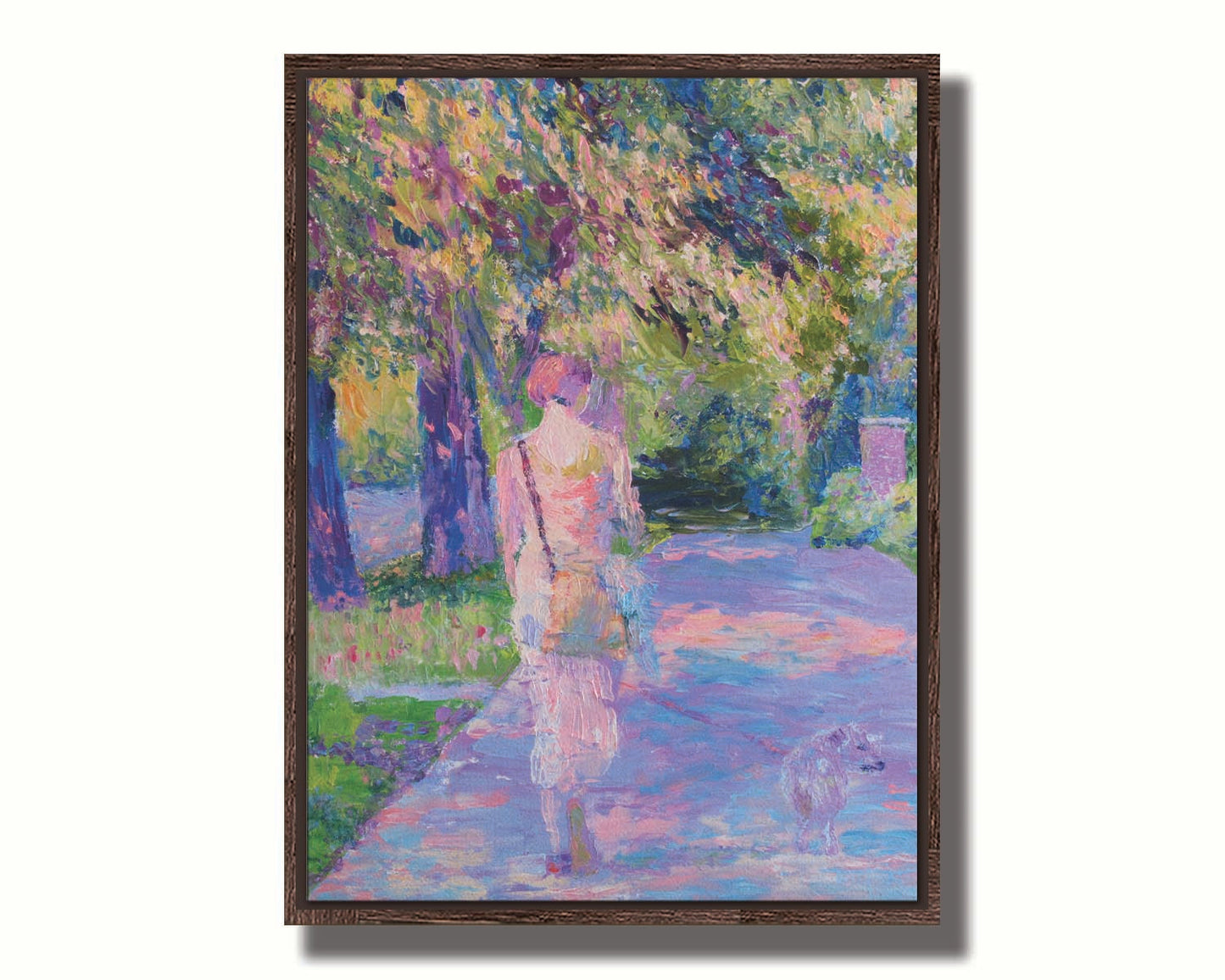 A painting of a woman walking her dog along a city sidewalk through a park. The leaved are turning yellow and red. Printed on canvas in a float frame.